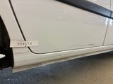 a white car with a sticker on the side of it ' s door