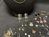 many different types of jewelry on display on a black table