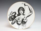 an image of a plate with a drawing of a woman holding two balls