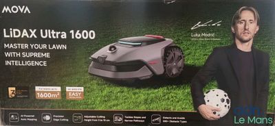 an image of a man standing next to a box of lawn mowers