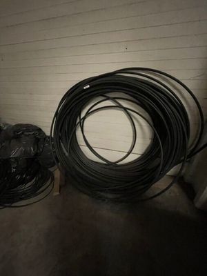 a pile of wires and a hose on the floor