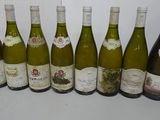 six bottles of white wine are lined up on a table