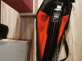 a bag and a tripod on the floor in a room
