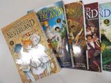 four children ' s books are lined up on a white surface
