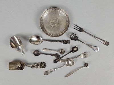 a lot of silver spoons and spoons on the table