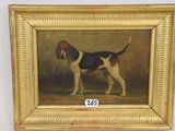 an oil painting of a dog in a gold frame on a wall