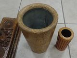 two vases sitting next to each other on a tile floor