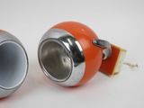 two orange and silver objects sitting on a white surface