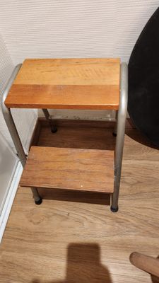 a small wooden table with a metal frame on it
