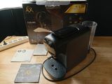 a coffee machine sitting on a table next to a box