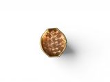 a close up of a gold ring on a white surface