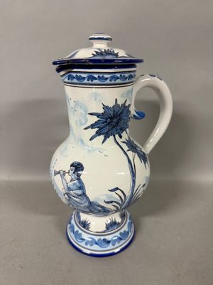 a blue and white vase with a bird on it
