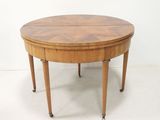 une table à manger ovale à deux pieds, avec un plateau en bois