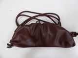 brown leather handbag on white surface with brown strap