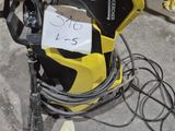 yellow and black electric pressurer sitting on the floor in a garage