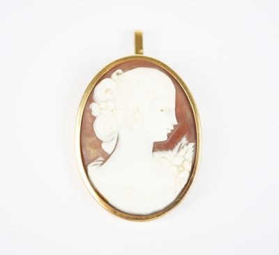 a gold and white cameo cameo of a woman with a flower in her hair