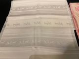 two napkins with horses on them on a table