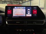 the dashboard of a car with a display of a car driving on a track
