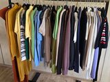 a rack of clothes hanging on a clothes rack in a room