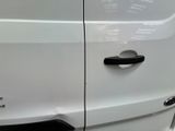 a close up of a white van with a black handle