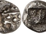 a silver coin with an image of a lion on it