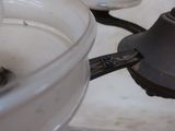 a close up of a bowl of water with a spoon in it