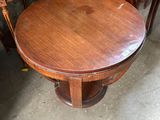 a wooden table and two chairs in a room
