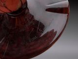 a close up of a glass vase with a bird on it