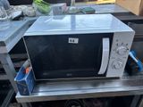 a microwave that is sitting on a metal table