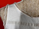 a close up of a dress on a mannequin on a red background