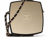 a chanel mirror bag with a chain around it