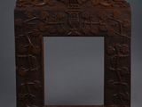 an old wooden frame with a carved design on it