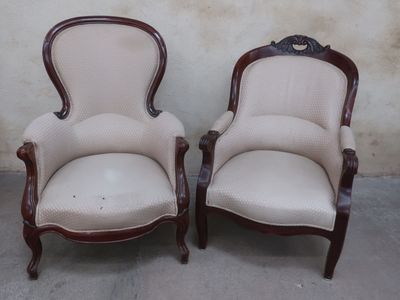 pair of upholstered armchairs with arms and legs