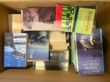 many books in a box that are sitting on top of each other