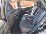 the back seats of a car with a cup holder in the passenger seat