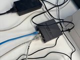 a laptop computer sitting on top of a table with many wires