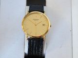yellow and black watch sitting in a box on a green surface
