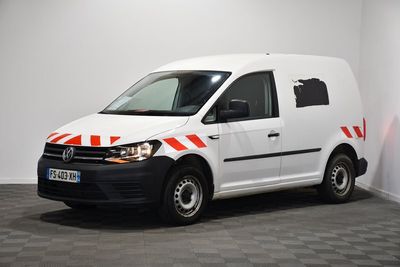 the white van is parked in a room with a checkered floor