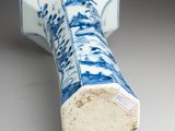 a blue and white vase sitting on a table