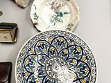 a plate with a flower design on it sitting on a table