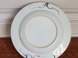 a white plate with blue and orange designs on it