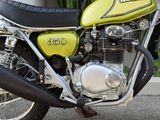 a yellow motorcycle parked in front of a building