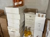 several bottles of wine are stacked on top of boxes in a room