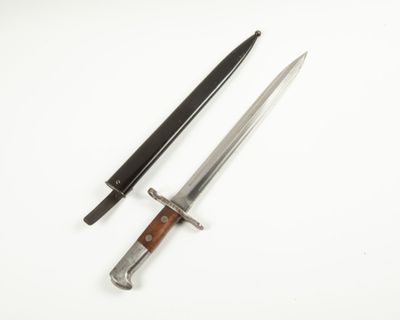 two knives on a white surface with a wooden handle