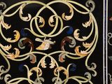 two panels with decorative designs on them on a black surface