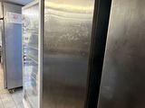stainless steel refrigerators in a commercial kitchen with tile flooring