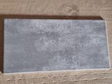 a picture of a piece of cardboard with a piece of cement in it