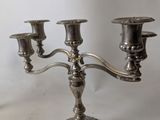 a silver candelab with three candles on it
