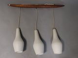 three white vases hanging from the ceiling of a room