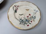 a plate with a butterfly on it sitting on a table